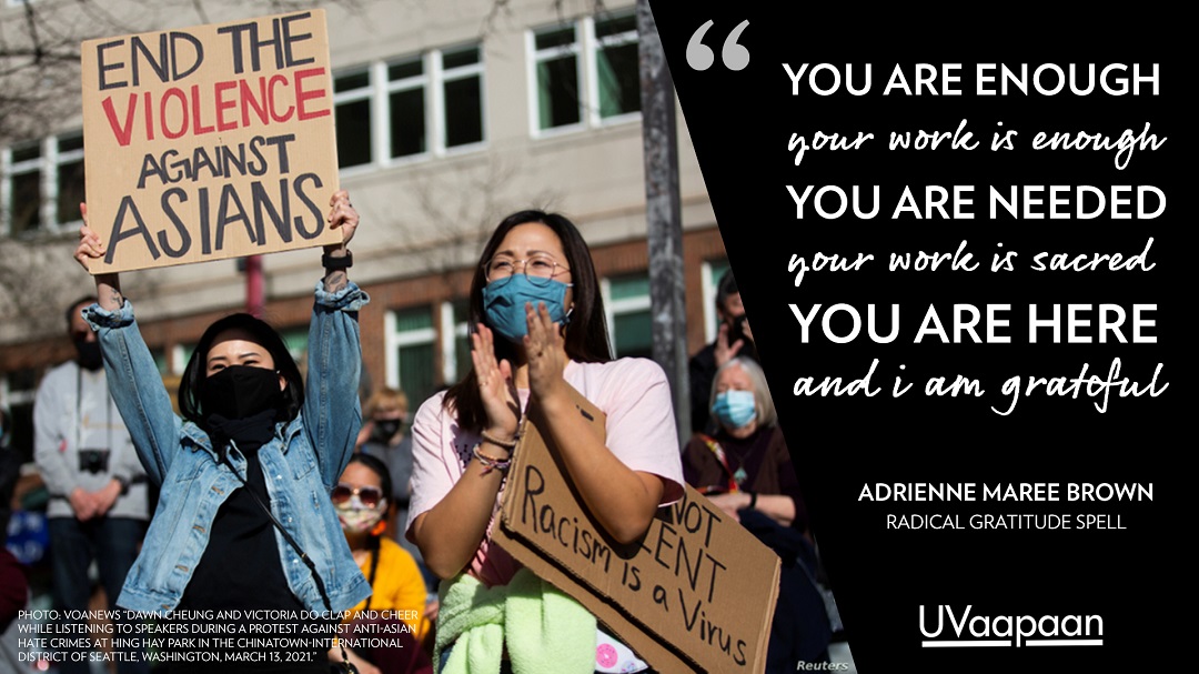 Protesters against anti-Asian hate crimes with a quote from Adrienne Maree Brown: 'You are enough; your work is enough; you are needed; your work is sacred; you are here and I am grateful'