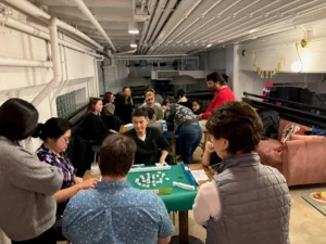 People gathered around a Mahjong table