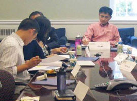 Photo of board members working around a table