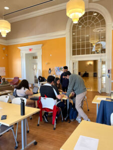 Bolivar members gathered around a table in conversation during the spring 2022 Spring Blast