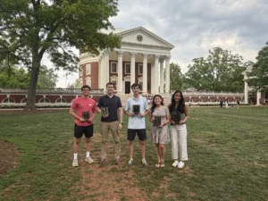 Photo of five scholarship winners standing with their awards on the Lawn in front of the Rotunda