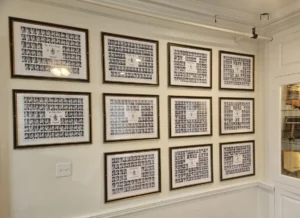 Picture of several class composites hanging on the wall at One University Circle