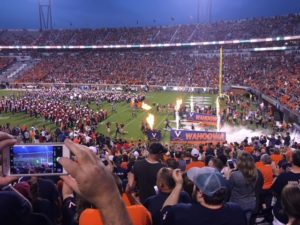 Home football game, players entering field