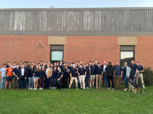 Group photo of rowing team with guest speaker, Arshay Cooper