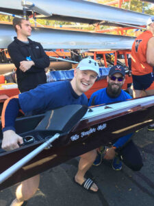 rowing member posing with "the people's eight"
